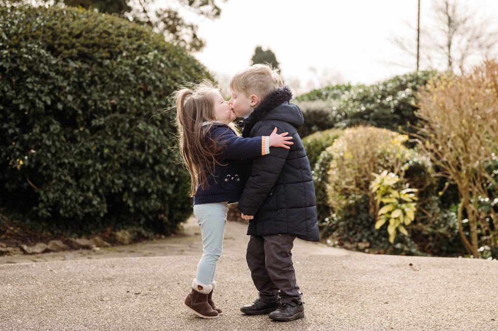 Lancashire family photographer at Clitheroe Castle with a little boy and a little girl kissing