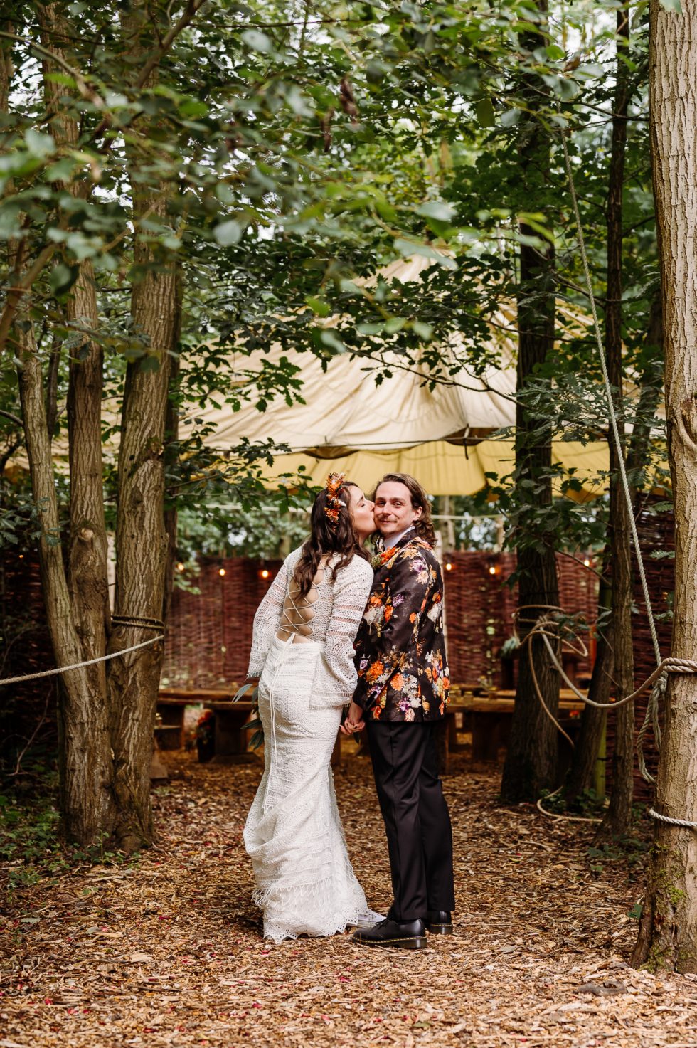 Alternative bride giving her husband a kiss and captured by Cockley Wood wedding photographer