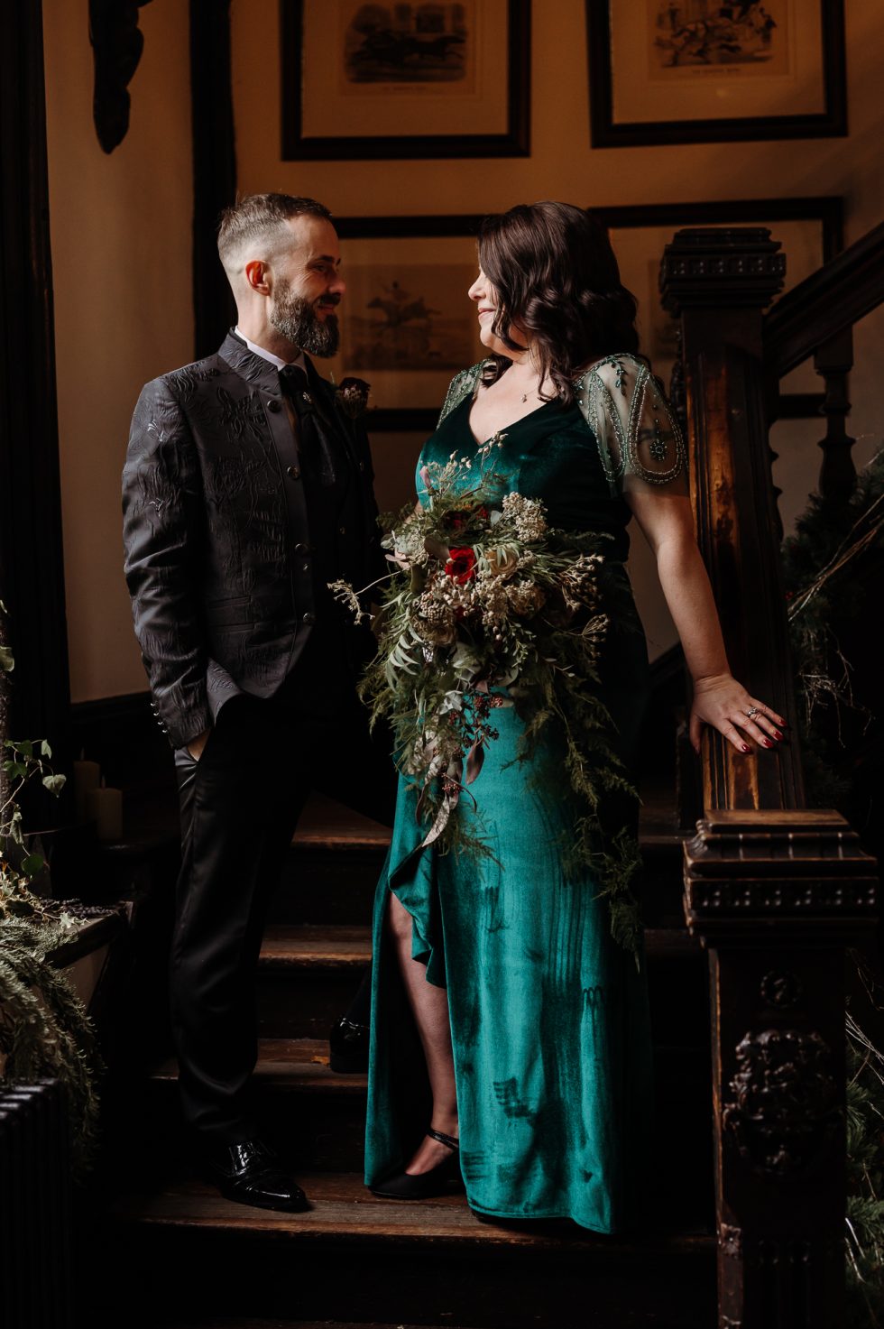 Alternative bride and groom stood on the stairs - captured by Samlesbury Hall wedding photographer
