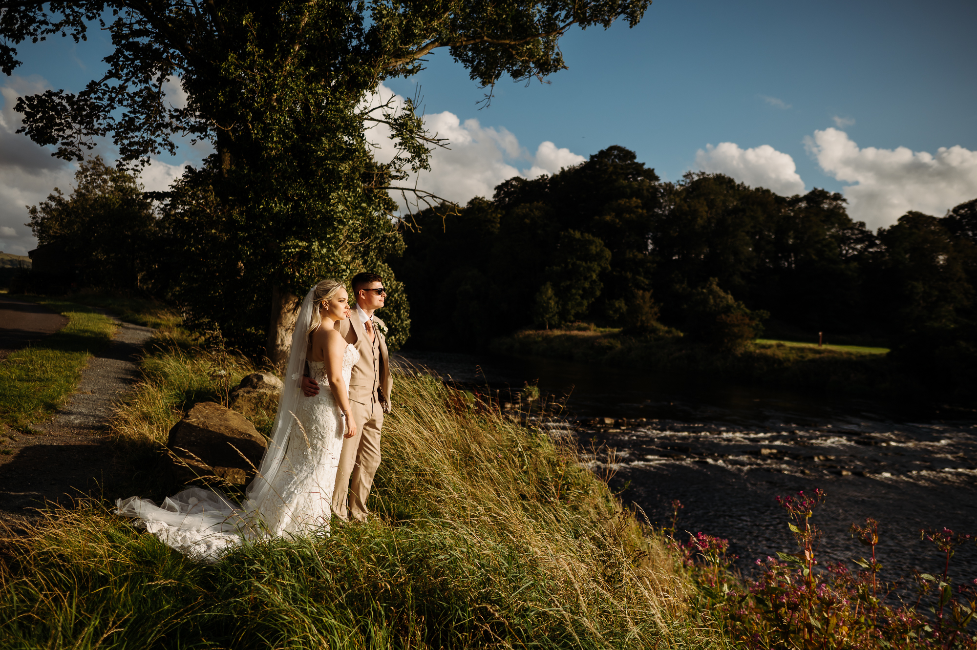 Gorgeous newlyweds in the golden sun looking over the river Ribble by Hobbit Hill