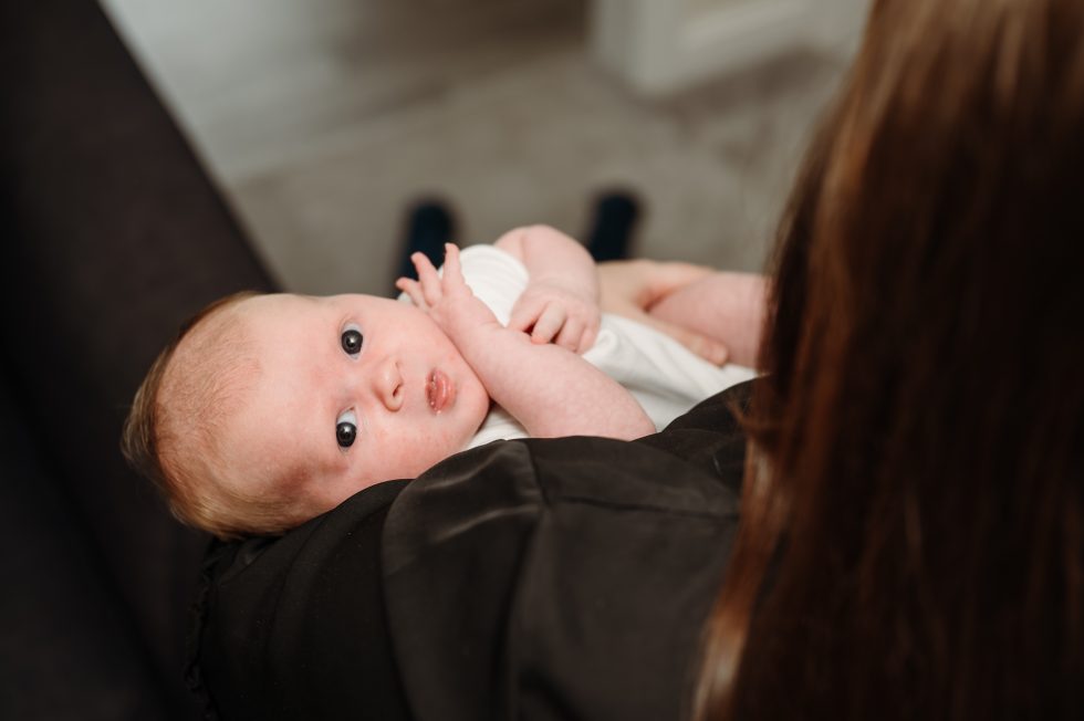 Newborn baby girl looking in to the camera