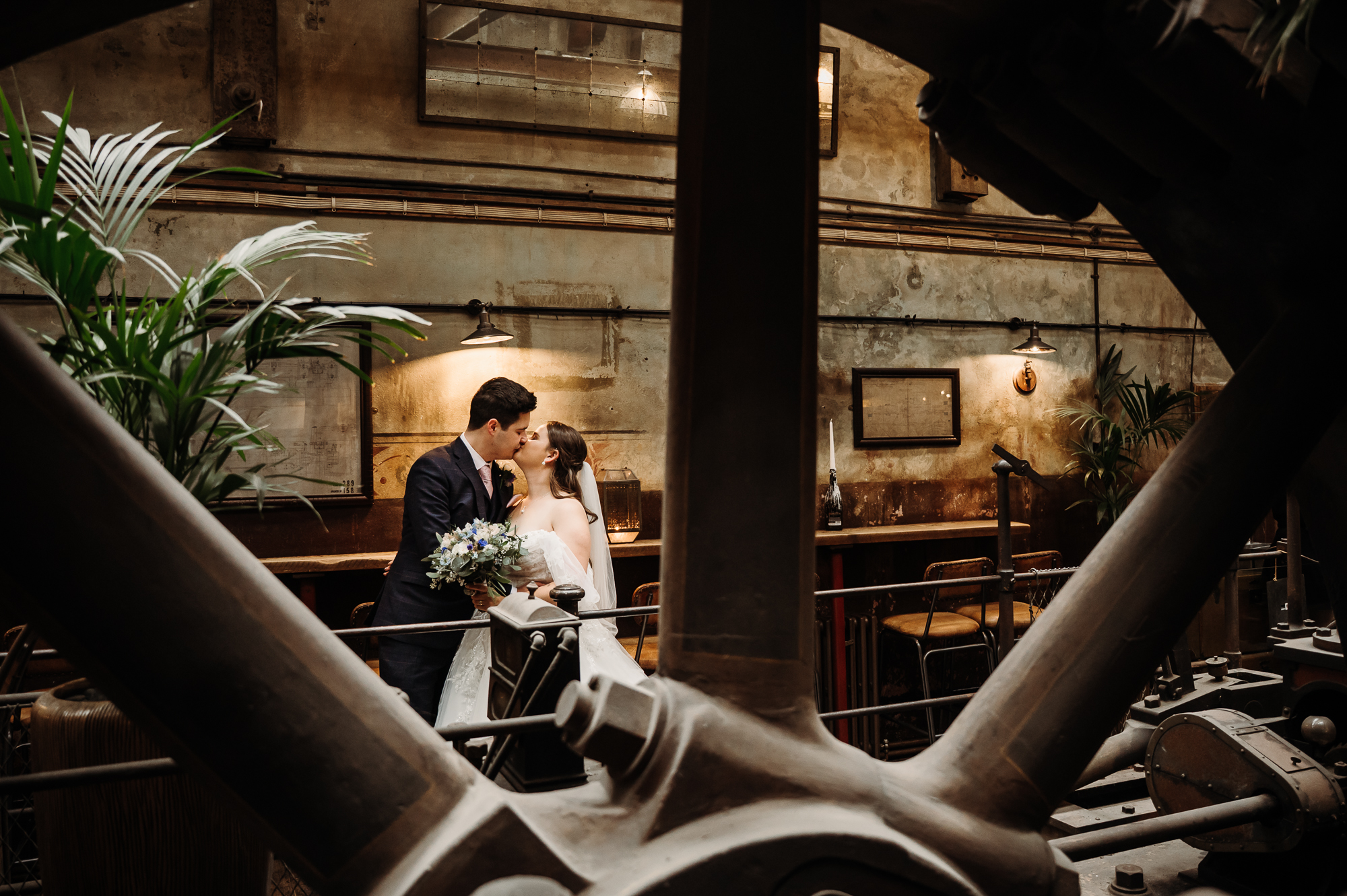 Holmes Mill Wedding Photographer -46 Bride and groom sharing a kiss in the boiler room by Holmes Mill Wedding Photographer