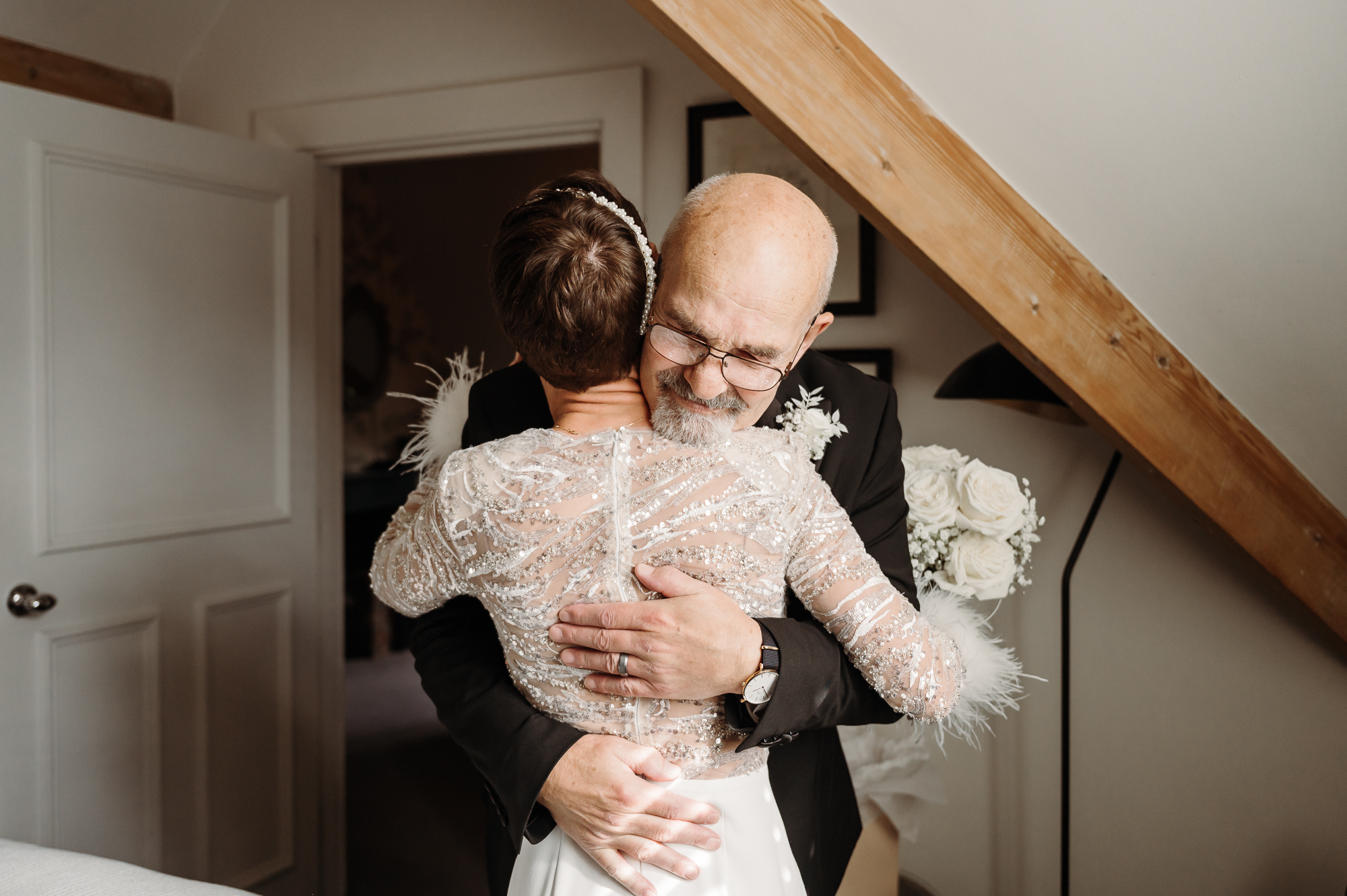 Father of the bride hugging his daughter by Didsbury House wedding Photographer