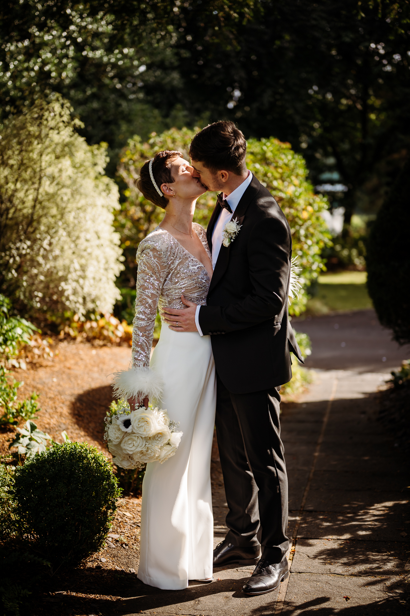 Bride and groom kissing in the garden by Didsbury House wedding Photographer