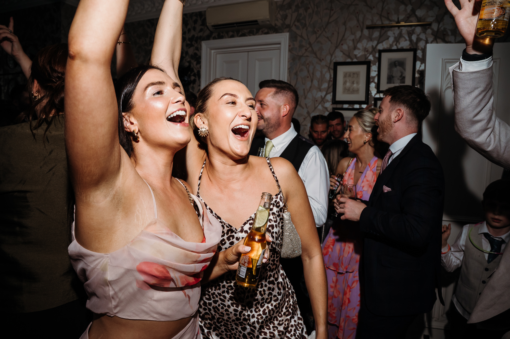 Wedding guests dancing with their hands in the air