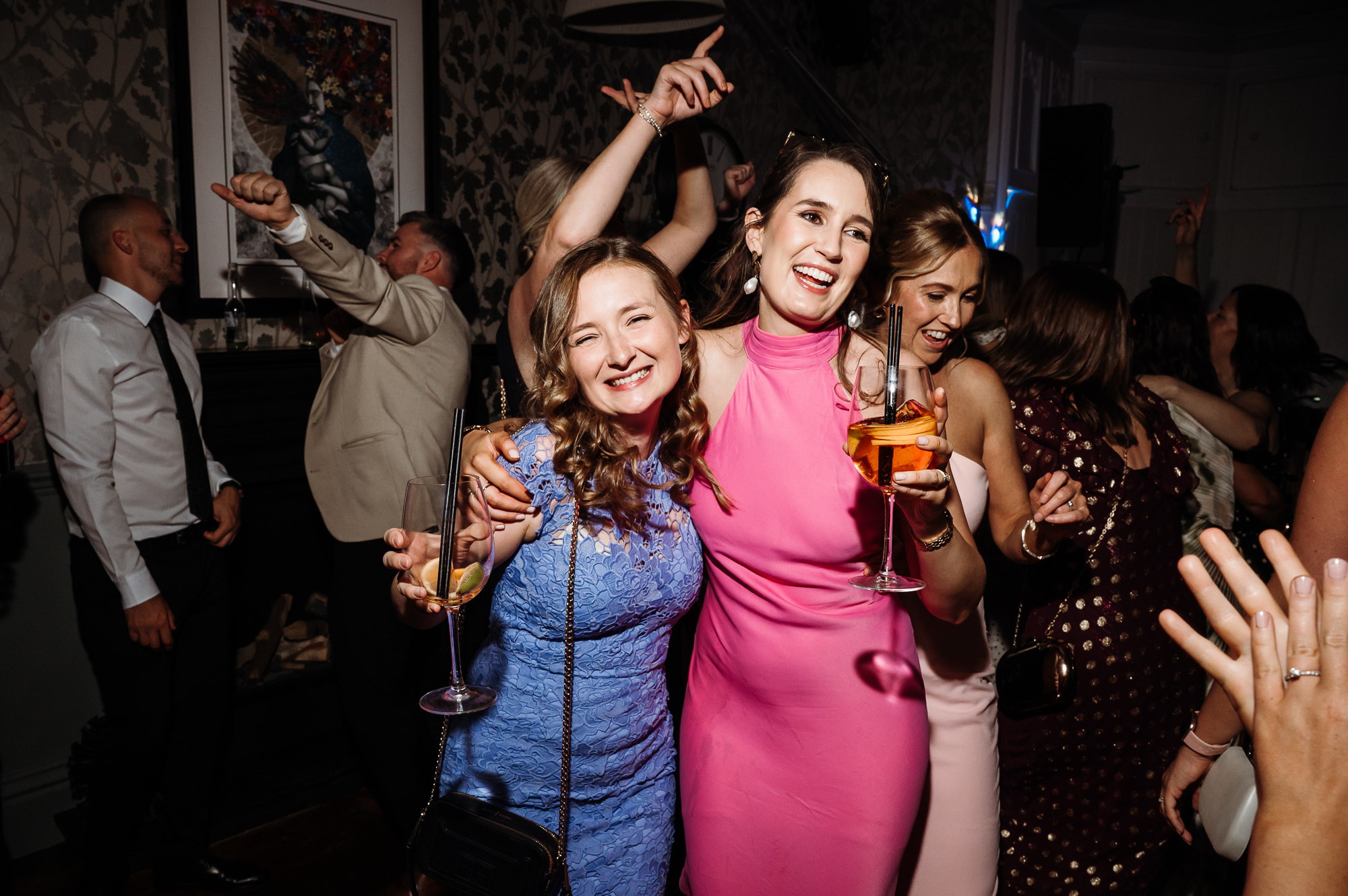 Wedding guests dancing by Didsbury House wedding Photographer
