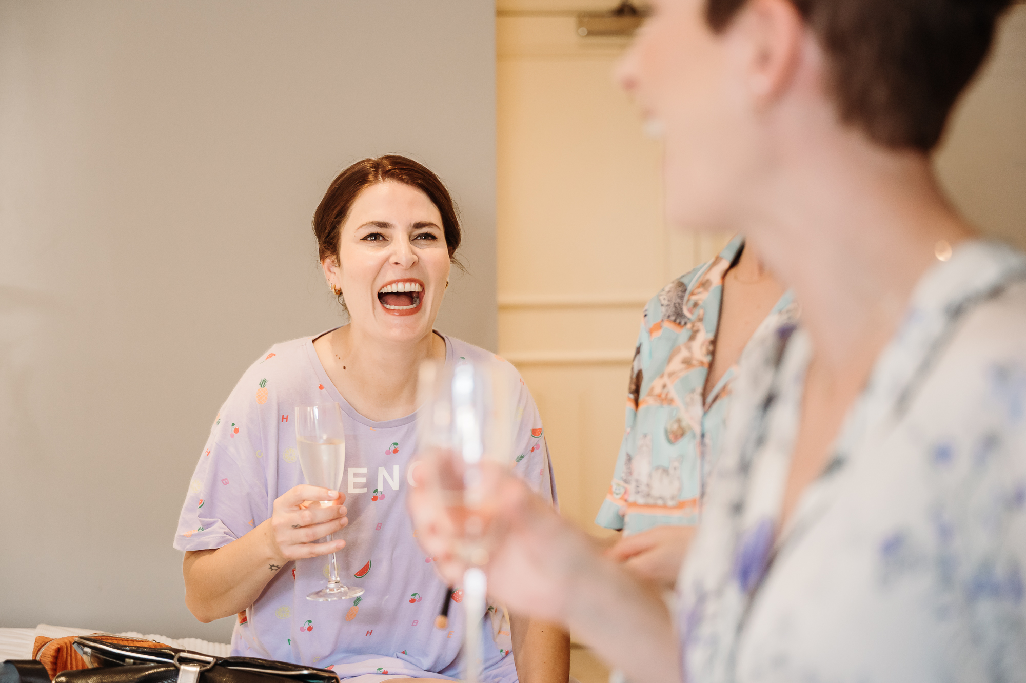 Sisters laughing during bridal preparation