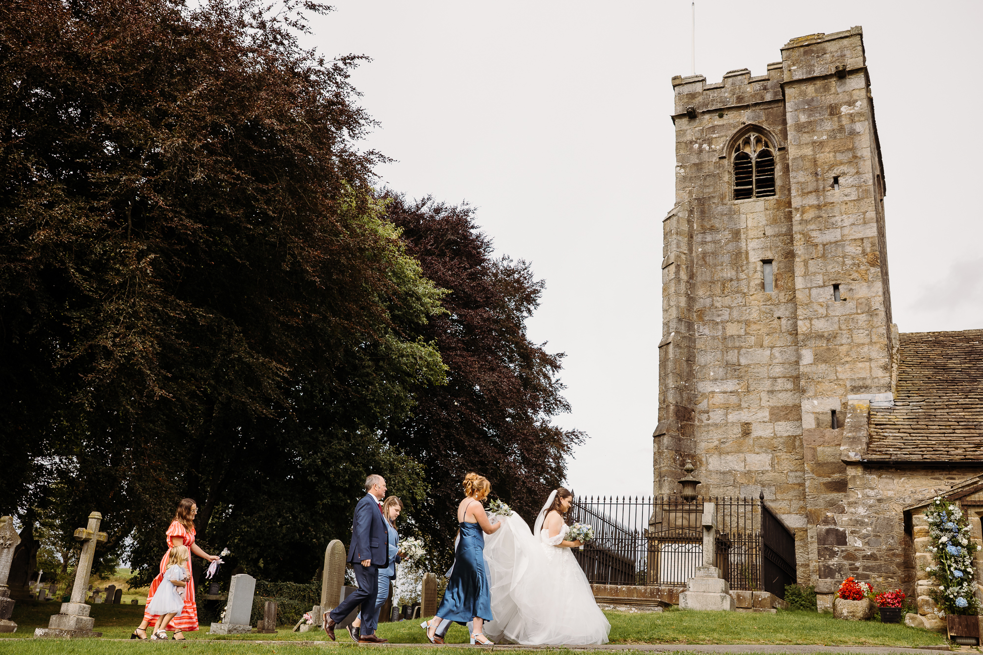 Bridal party walking into the church in Lancashire