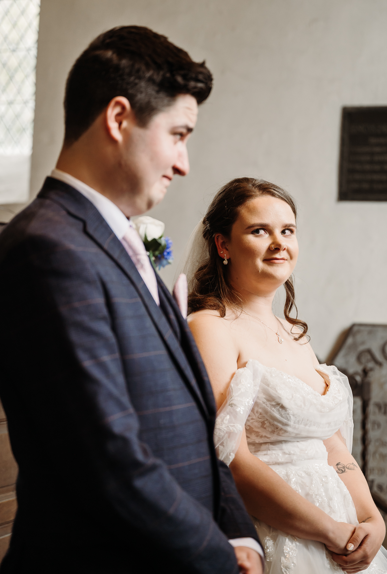 Bride looking at her groom during the church ceremony