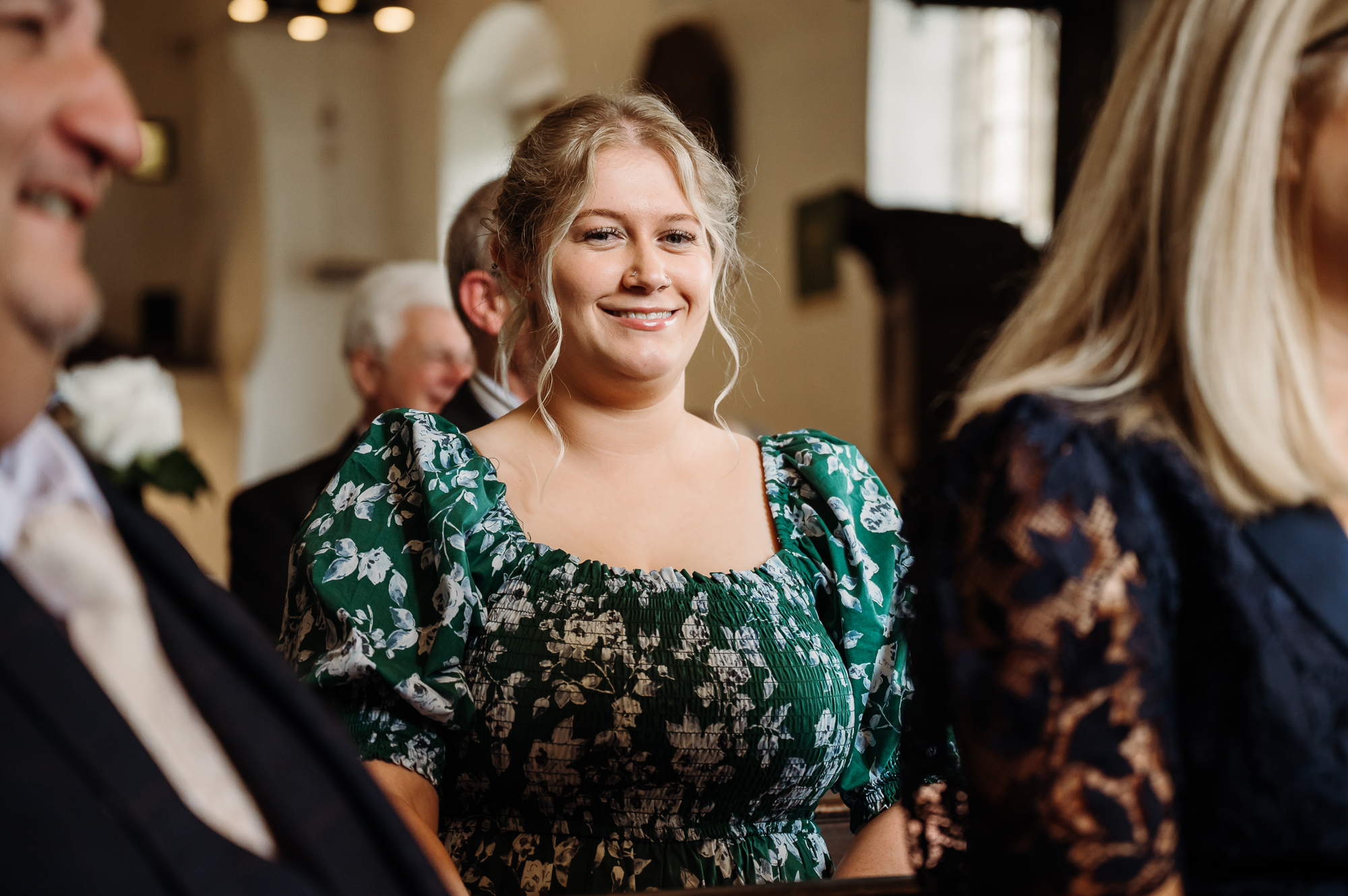 Wedding guest smiling during Lancashire church wedding