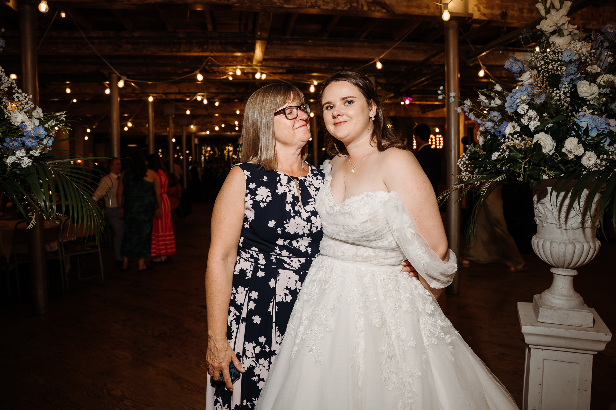Bride and her mum. Mum is looking proudly at her daughter