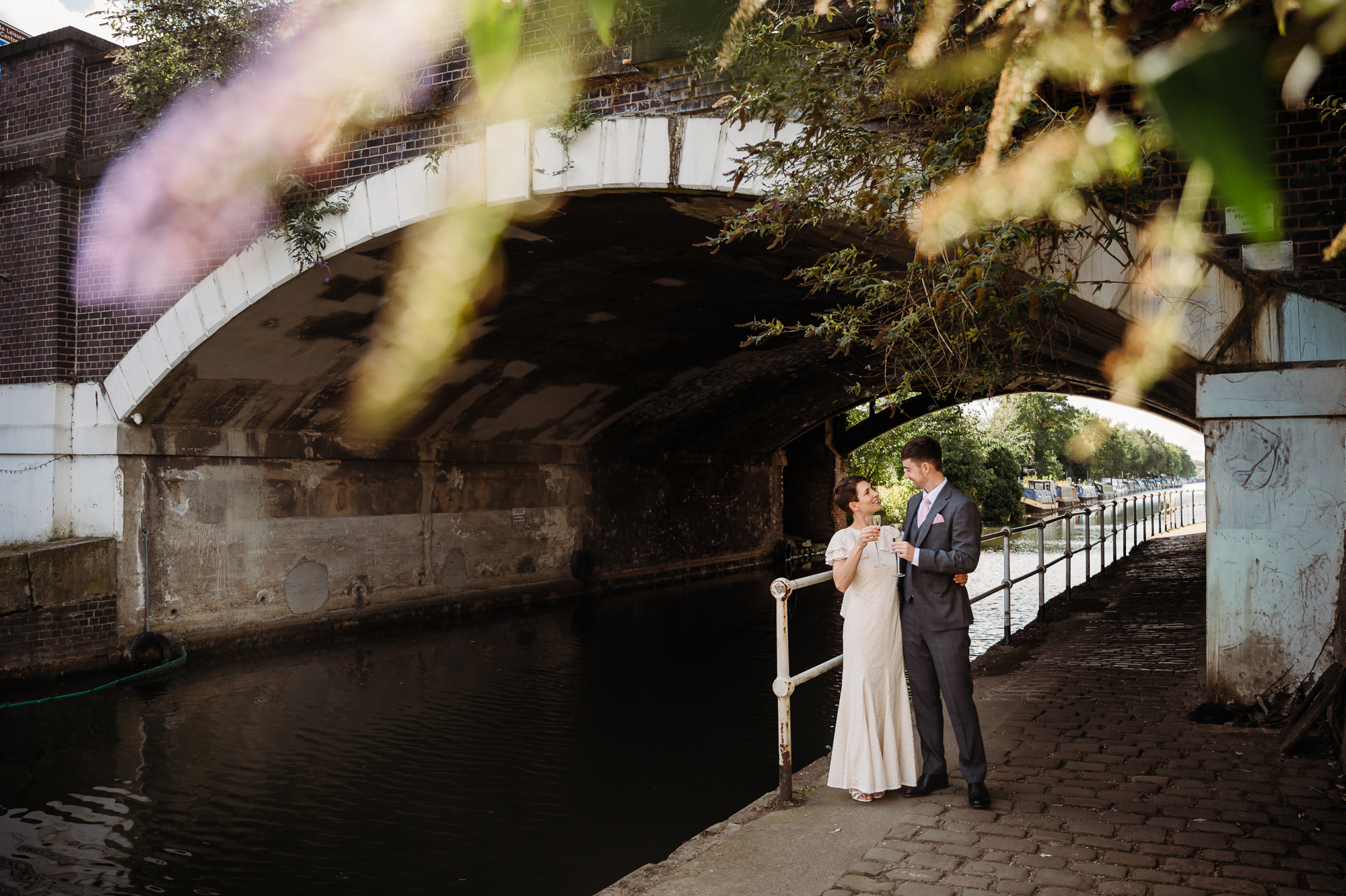 Cute couple kissing by a bridge by the canal