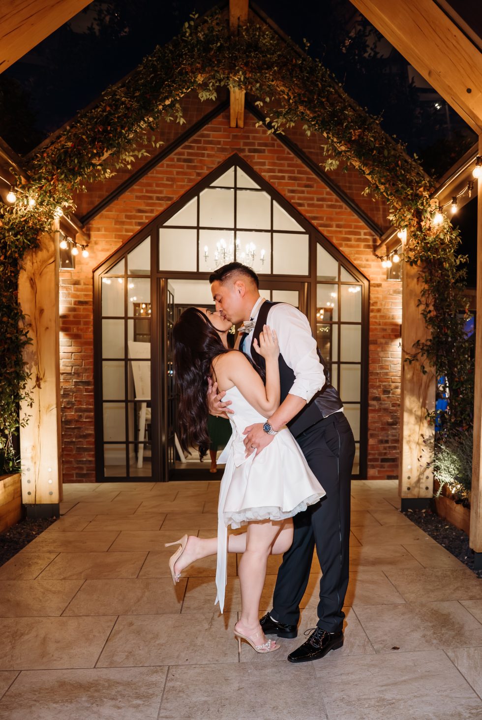 Bride and groom kissing outside battle hall