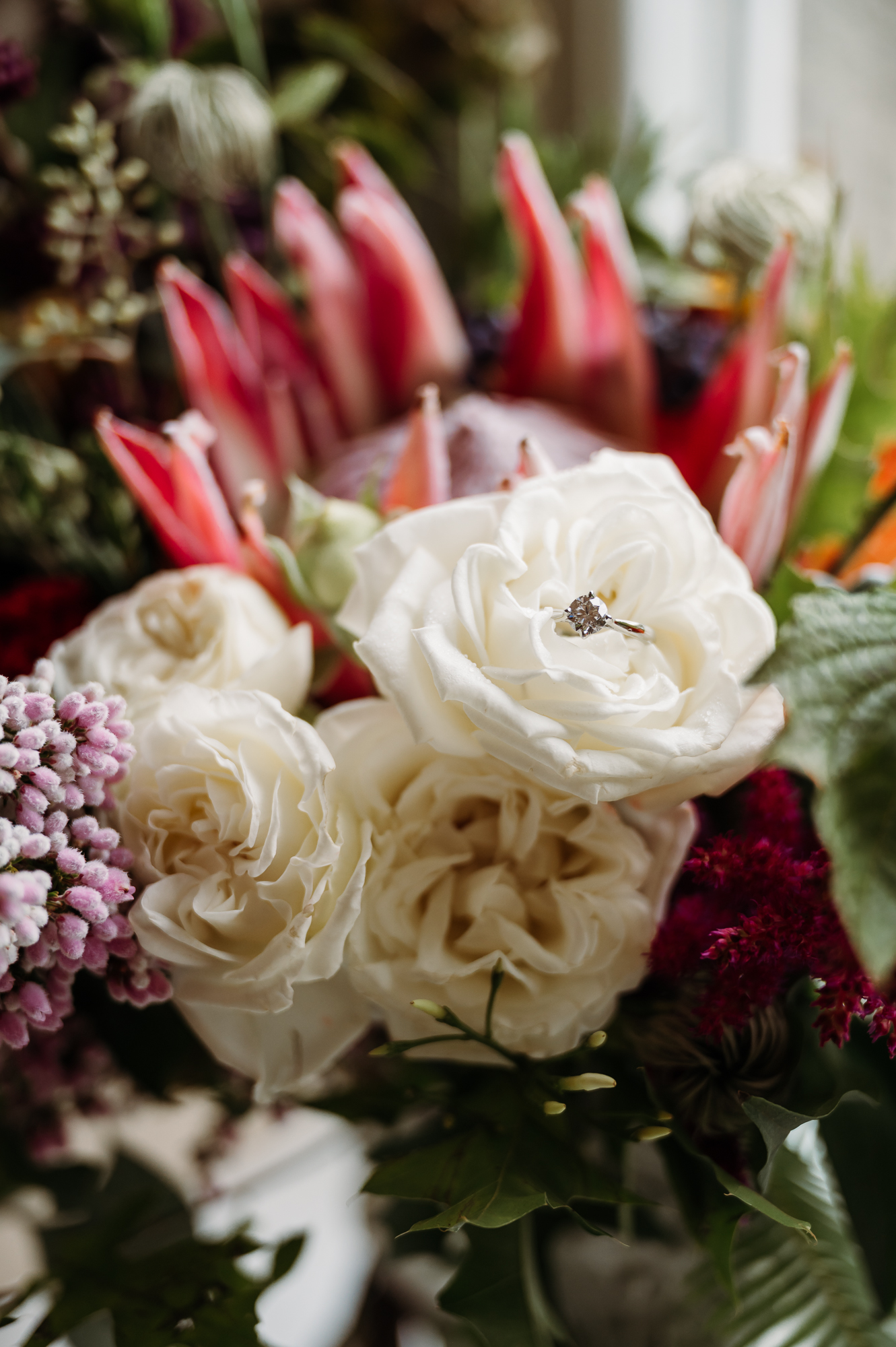 Brides engagement ring resting in her wedding bouquet by Browsholme wedding Photographer