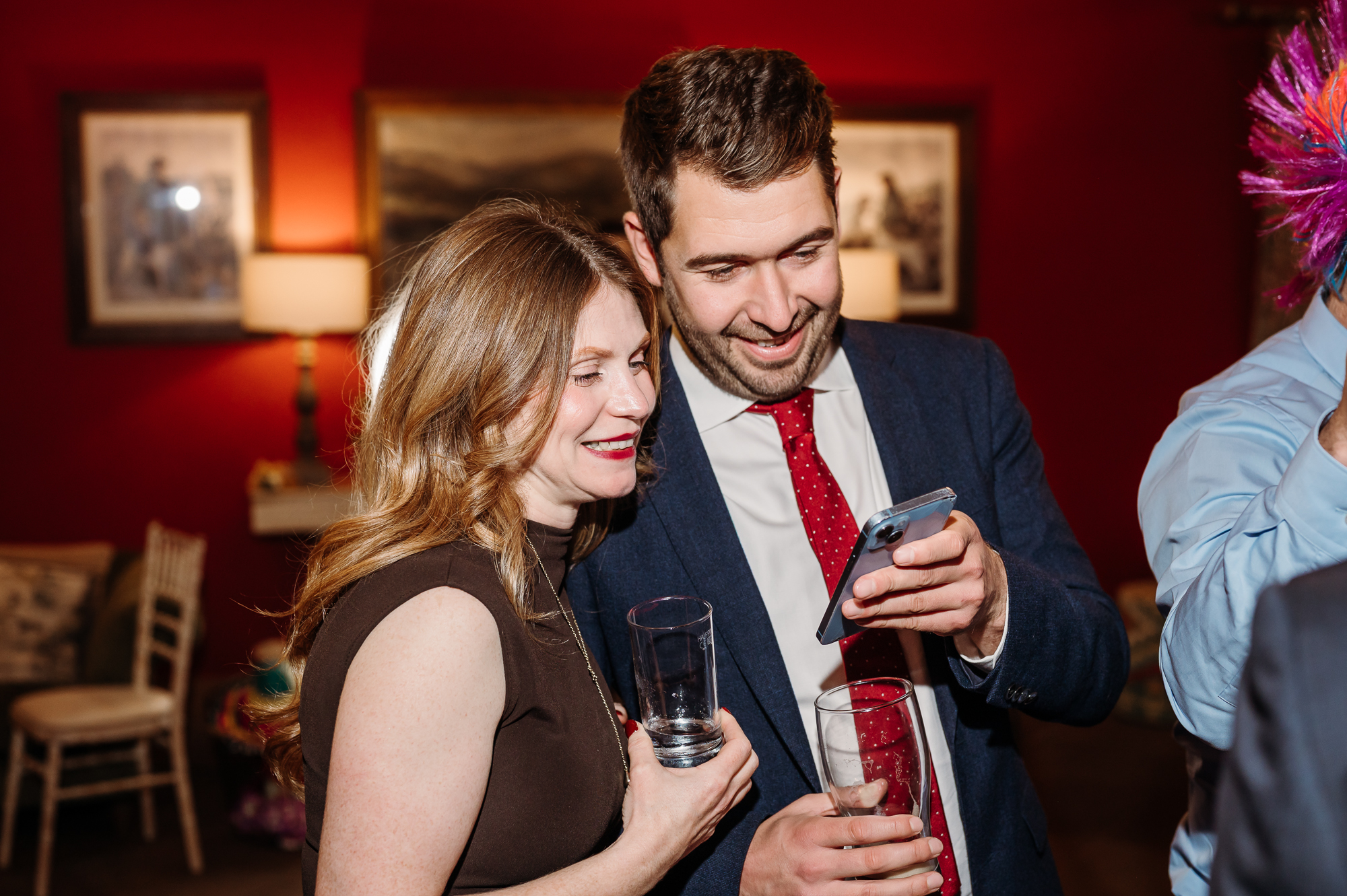 Candid shot of wedding guests laughing.