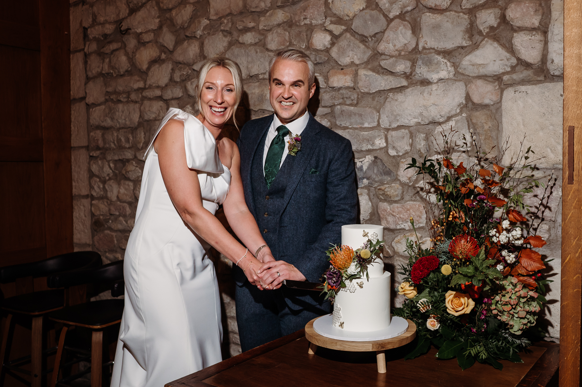Bride and groom cutting the cake.