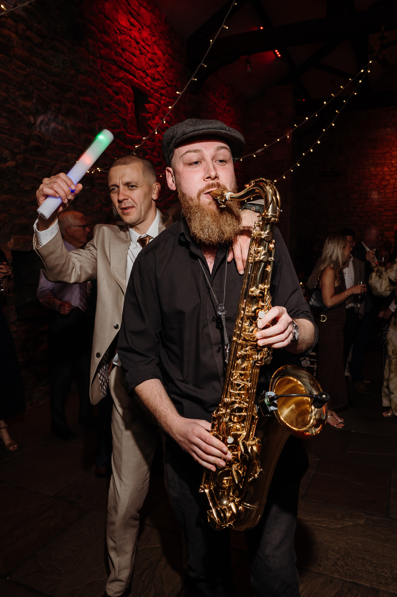 Man playing the saxophone in the middle of the dance floor by Browsholme Hall Wedding Photographer