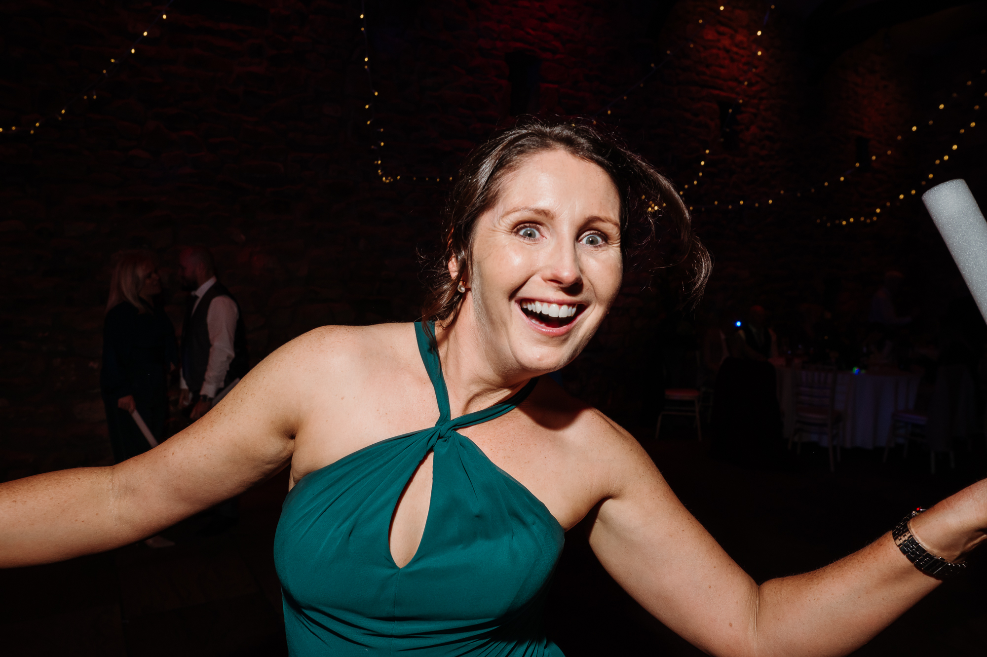 Bridesmaid dancing towards the camera.
