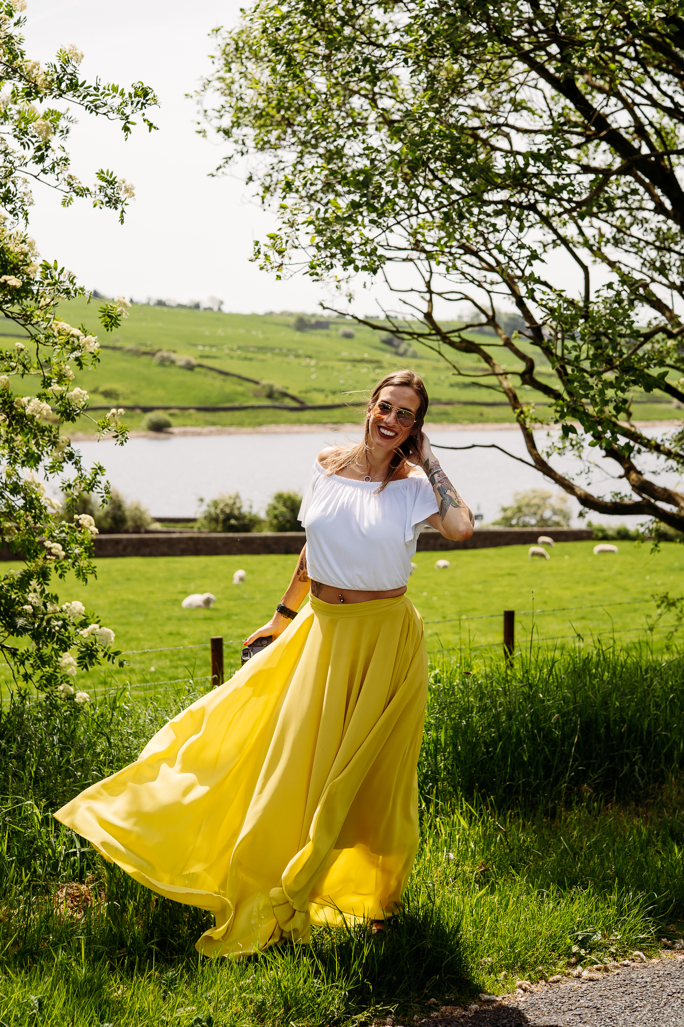 Jane Green, Lancashire wedding photographer with a Ribble Valley view behind her