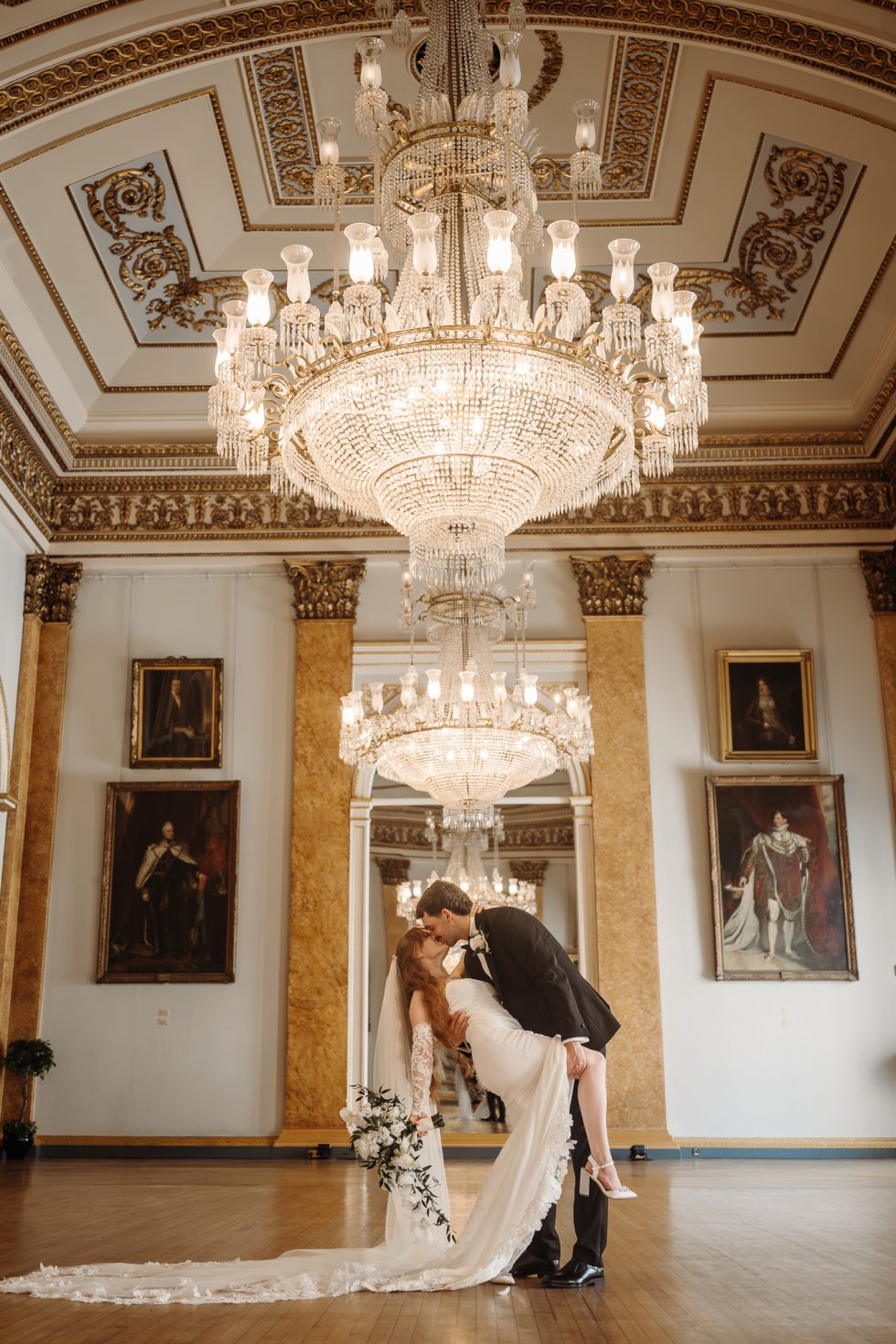 Bride and groom during a dip kiss under the chandelier at Liverpool Town Hall by Lancashire wedding photographer