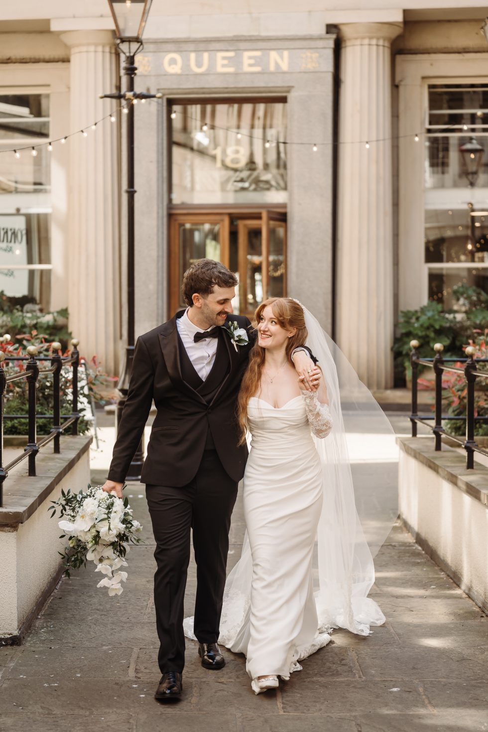 Bride and groom walking through the streets in Liverpool